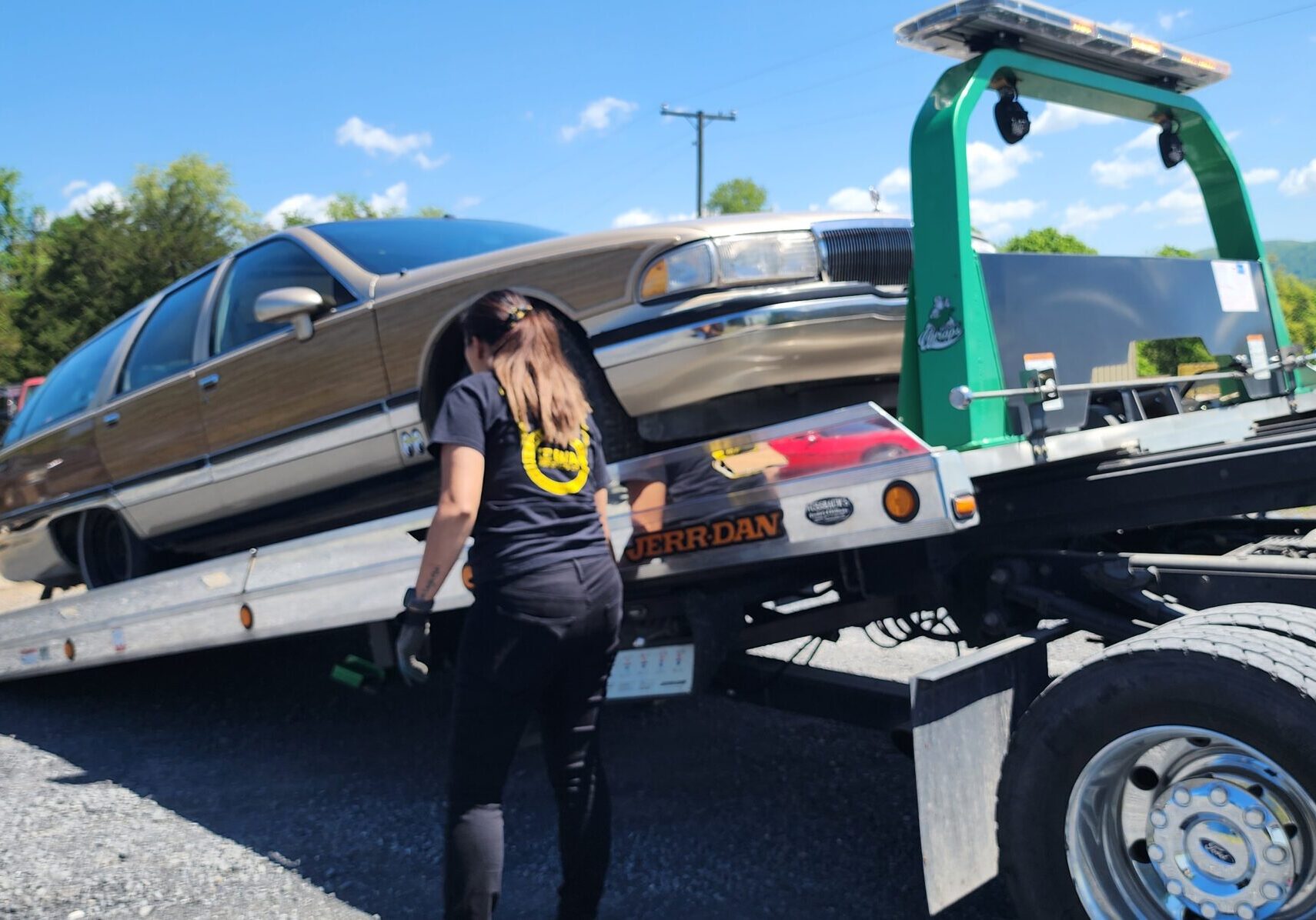 juliaa loading woodgrain buick roadmaster wagon on a rollback tow truck